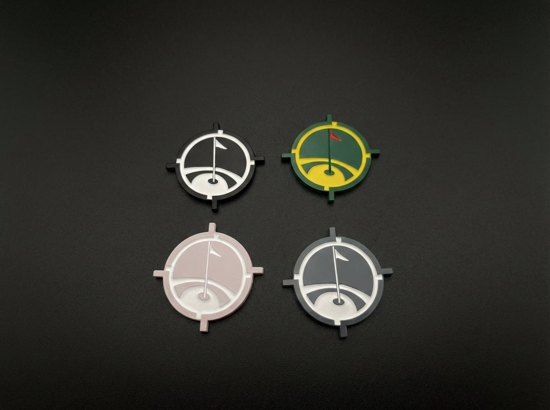 Magnetic golf ball marker shown in multiple color options on dark background