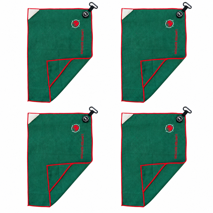 Four Reserve Evergreen magnetic golf towels with red trim on a clean white background