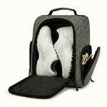 Golf shoe bag open with a pair of golf shoes stored inside the main compartment.