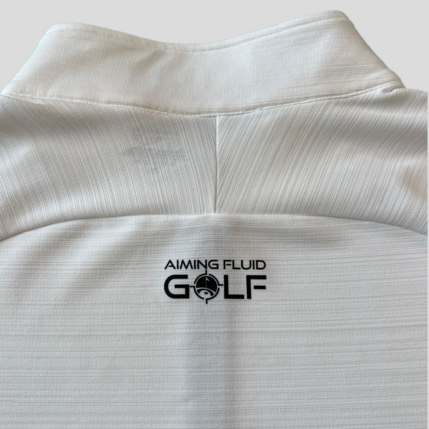 A photograph of the back collar of The Perfect Pullover t-shirt from Aiming Fluid Golf.