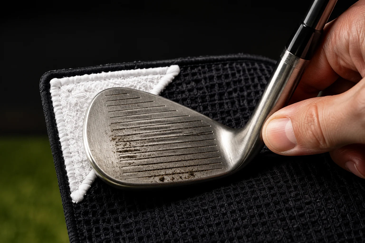 Get into the grooves. Work the corner scrub pad across the clubface to loosen dirt.